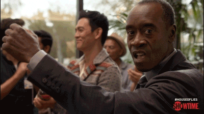 TV gif. Don Cheadle as Marty Kaan in House of Lies wears a suit and tie and stares over his shoulder towards us. He repeatedly raises a fist and pulls it back like an old-fashioned cash register. White money symbols appear in front of him. 