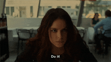 TV gif. Emily Hampshire as Jennifer Goines on 12 Monkeys leaning over a table and looking stern as she says "do it!"