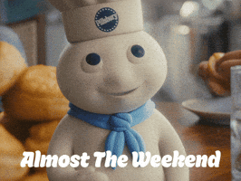 Sponsored gif. The Pillsbury Doughboy, in his iconic blue scarf and Pillsbury chef hat, stands on a table in front of a plate of biscuits and counts on his fingers. Text: "Almost the weekend" 