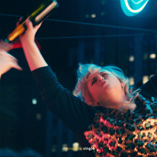 Movie gif. Rebel Wilson as Robin from How to be Single holds an empty bottle of champagne, hanging off of something just out of frame. Her eyes are closed and she screams, "Woo!" clearly the life of the very raucous party.