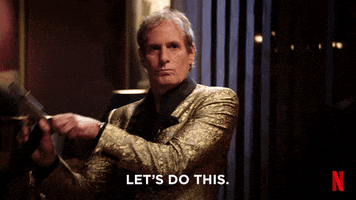 Movie gif. Michael Bolton in his Big, Sexy Valentine’s Day Special wears a golden, sparkly suit. He has a serious expression on his face as he cocks the gun in his hand and says, “Let’s do this.”