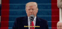 Political gif. Trump stands in front of a cheering crowd and speaks into the microphone while pumping a fist in the air saying, "God Bless America!"