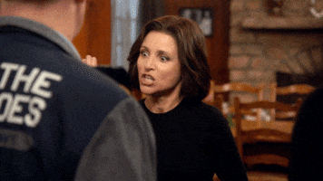 TV gif. Julia Louis-Dreyfus, as Selina in Veep, gives several people a high five and yells, “Good job!”