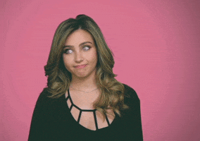 Celebrity gif. Ryan Whitney smirks and shrugs her shoulders. Text, "Sorry."