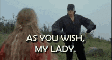 Movie gif. Cary Elwes as Westley in The Princess Bride dressed as the Dread Pirate Roberts bows to the princess and says, "As you wish, my lady."
