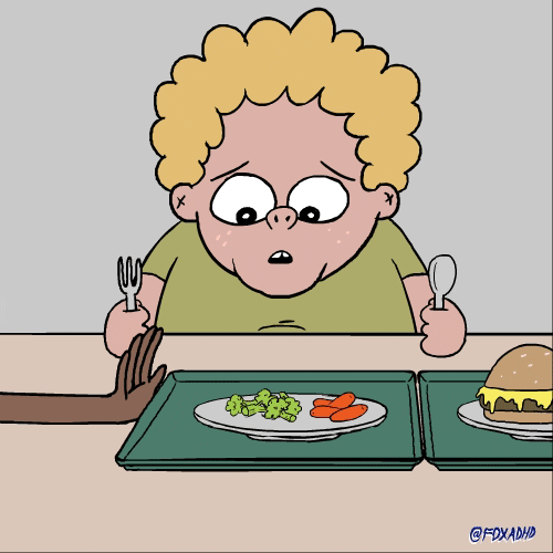 Cartoon gif. A chubby kid sits with a fork and spoon in his hands, ready to eat. He looks excitedly at the food tray with a burger and fries that’s pushed in front of him. Then he looks disappointingly at a tray with broccoli and carrots when it’s pushed in front of him. 