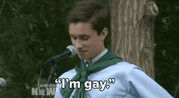 Video gif. A teenager looks down nervously as they speak into a microphone. They shake a bit as they say, “I'm gay.”