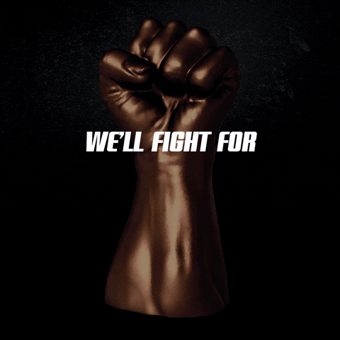 Digital art gif. Chocolatey-bronze raised fist of solidarity spins as if on a lazy susan display, bold shiny text reminiscent of the Fast and the Furious logo rolls in and glistens. Text, "We'll fight for, our, future."