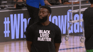 Celebrity gif. Jaylen Brown is on a basketball court with his hands behind his back and he nods strongly. He wears a shirt that says, “Black Lives Matter.”