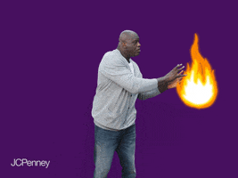 Celebrity gif. Shaquille O'Neal picks up an animated ball of fire and shoots it up in the air like it’s a basketball. He has a pretend concentrated look on his face like he’s really making a shot on the court.