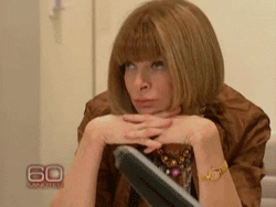 Celebrity gif. Anna Wintour leans unimpressed on her hands as she rolls her eyes. 