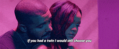 Music video gif. From the video for Work, Drake whispers into Rihanna's ear from behind as they dance beneath blue and pink lighting, singing, "If you had a twin I would still choose you," which appears as text.