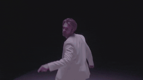 A gif of FINNEAS pointing at the camera while singing.