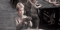 Movie gif. John Howard Davis as Oliver in Oliver Twist. He looks forlorn as he holds an empty bowl out and begs for more food.
