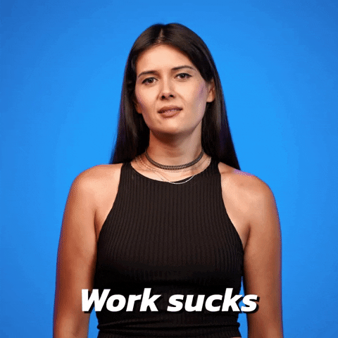 Video gif. Woman looks at us and tries to roll her eyes, but one eye twitches closed as she says, “work sucks.”
