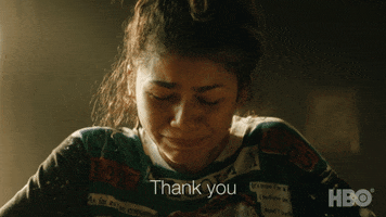 TV gif. Zendaya as Rue in Euphoria looks down with hunched shoulders, sobbing and wiping away tears from her face as she looks towards us with a grateful expression. Text, "Thank you."