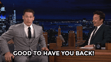 Tonight Show gif. Jimmy Fallon and John Cena look out at an audience. John Cena gestures to the audience with a welcoming nod. Text, "Good to have you back!"