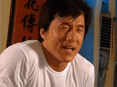 Movie gif. Jackie Chan hungrily licks his lips.
