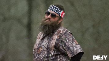 Reality TV gif. Willie from Duck Dynasty has his hands on his hips and stares at us while shaking his head in disappointment.