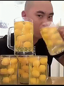 Video gif. A man swiftly chugs raw eggs from five full large beer glasses. 