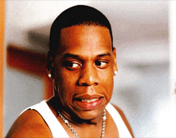 Celebrity gif. Jay Z walks into a room and sees something he knows he shouldn't see. He pulls a face and scrunches his shoulders before awkwardly turning away.
