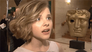 Celebrity gif. Chloe Moretz reacts in puzzlement, then looks up, thinking.
