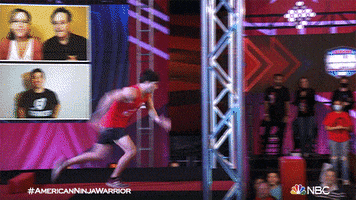 Reality TV gif. Contestant on American Ninja Warrior runs fast off a platform and then on top of spaced-out fragile red pillars.