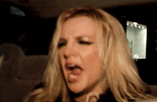 Celebrity gif. Britney Spears in the backseat of a car, yawning big and then plopping her head back against the headrest.