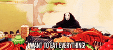 Anime gif. No Face from the movie Spirited Away flings his arms up in the air as he sits behind an overwhelming array of food. He proclaims, "I want to eat everything!"