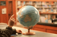 A hand spinning a globe real fast.