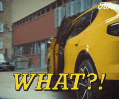 Sponsored gif. Man kicks open the door of a yellow vehicle and then peeks outside behind the car. He arches one eyebrow dramatically in question. Text reads, “What?!”