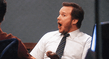 Parks and Recreation gif. Chris Pratt as Andy Dwyer lights up in excited surprise as he reacts to shocking news with his mouth agape.