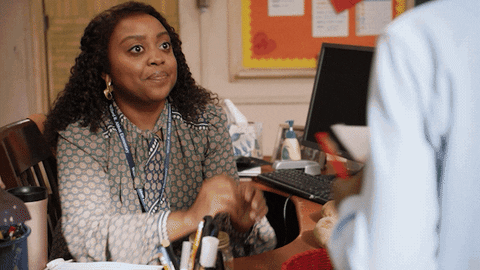 TV gif. Quinta Brunson as Janine Teagues on Abbott Elementary looks at us with big guilty eyes. She shrugs with a nervous smile and her eyes dart away. 