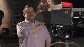 Celebrity gif. Patton Oswalt directs behind a camera, wagging his hand over his neck in disapproval and saying "no."