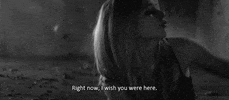 Music video gif. Avril Lavigne in her music video for Wish You Were Here. She's sitting on the floor and sadly sings, "Right now, I wish you were here."