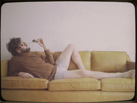 Ad gif. A hairy man lounging on a couch in his beige boxers holds a rose to his face while turning to look at us sexily. Then cut to other angles of him looking at us sexily in his Pit Viper sunglasses.