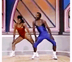 Video gif. 80s video of a woman and man in aerobics outfits cheerfully dancing and flexing their muscles. Multicolored text repeats up the center of the frame, growing larger each time it appears. Text, "Yeah!"