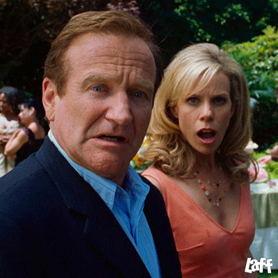 Movie gif. Cheryl Hines as Jamie and Robin Williams as Bob in RV. They're both slack jawed as they stare at something, stunned, and Jamie faints dead away, falling to the floor in a plop.