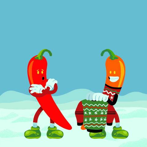 Illustrated gif. Two chili peppers in a snowy scene, a word bubble appears as one says "I'm a little chili," and the other offers him a sweater that matches his own. Text, "Spread love not hate."