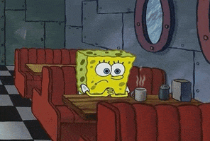 Spongebob gif. SpongeBob sits in a restaurant in a booth. He looks down sadly at a steaming cup of coffee. He has his hands clasped together on the table.
