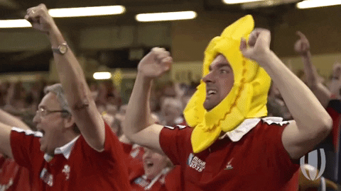 A Welsh rugby fan cheering in Cardiff city.