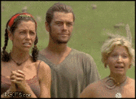 Reality TV gif. Three Survivor cast members stand together. The two women drop their jaws in shock and cover their mouths as a man between them smiles. 