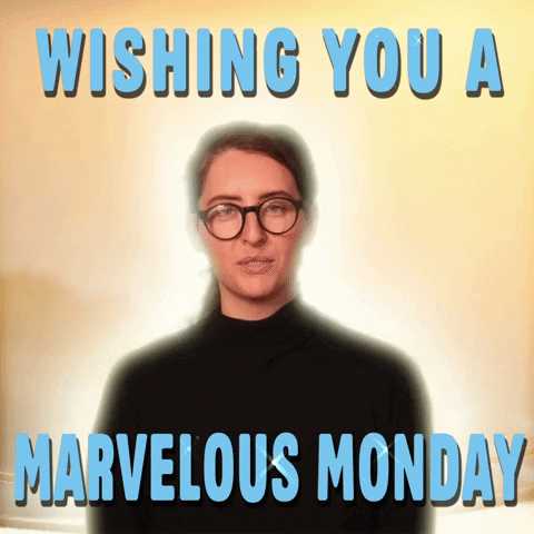 Video gif. A woman wearing glasses and a black shirt stands in front of a bright, glowing sunrise background. Sparkly text, "Wishing you a Marvelous Monday."