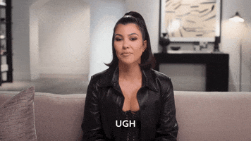 Reality TV gif. Kourtney Kardashian sits on a couch. She has a blank expression on her face as she sticks her tongue out and says, “Ugh.”