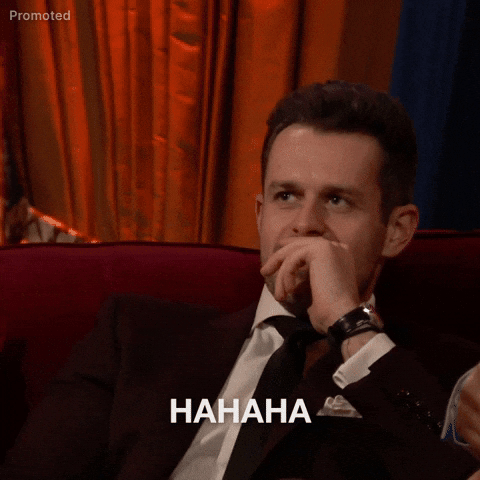 TV gif. Bachelorette contestent Jeremy Simon leans forward from relaxed seated position to let out a boisterous laugh.