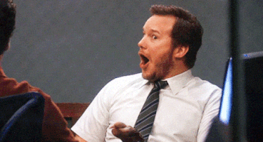Parks and Recreation gif. Chris Pratt as Andy Dwyer lights up in excited surprise as he reacts to shocking news with his mouth agape.