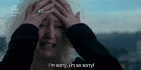 Video gif. A woman is sobbing and clutching her face, her hair completely disheveled. She has tears in her eyes as she says, "I'm sorry, I'm so sorry!"
