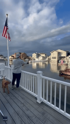 Man Reels in Fish From Floodwater on Home Deck