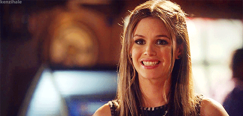 TV gif. Rachel Bilson as Zoe in Hart of Dixie. She gives a wide, sheepish smile as she raises her shoulders and shrugs in encouragement.