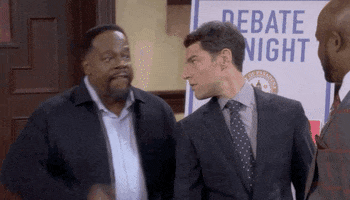 TV gif. Max Greenfield as Dave from The Neighborhood turns affirmatively toward Cedric the Entertainer as Calvin who chops the air with one hands and says, "Facts!"